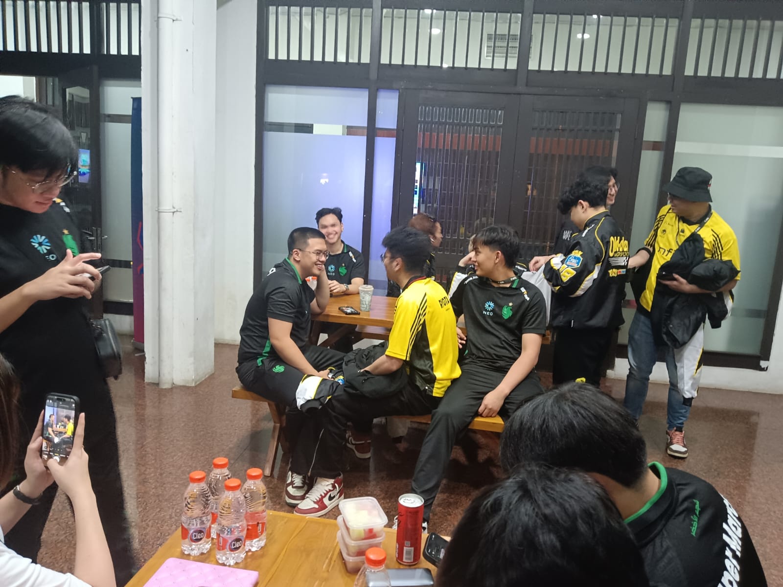 Bali Tourism Festival booth with TransTour banners and staff interacting with visitors