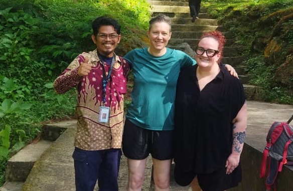 Experienced male guide explaining historical artifacts in museum setting