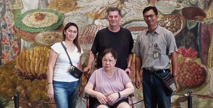 Experienced male guide explaining historical artifacts in museum setting